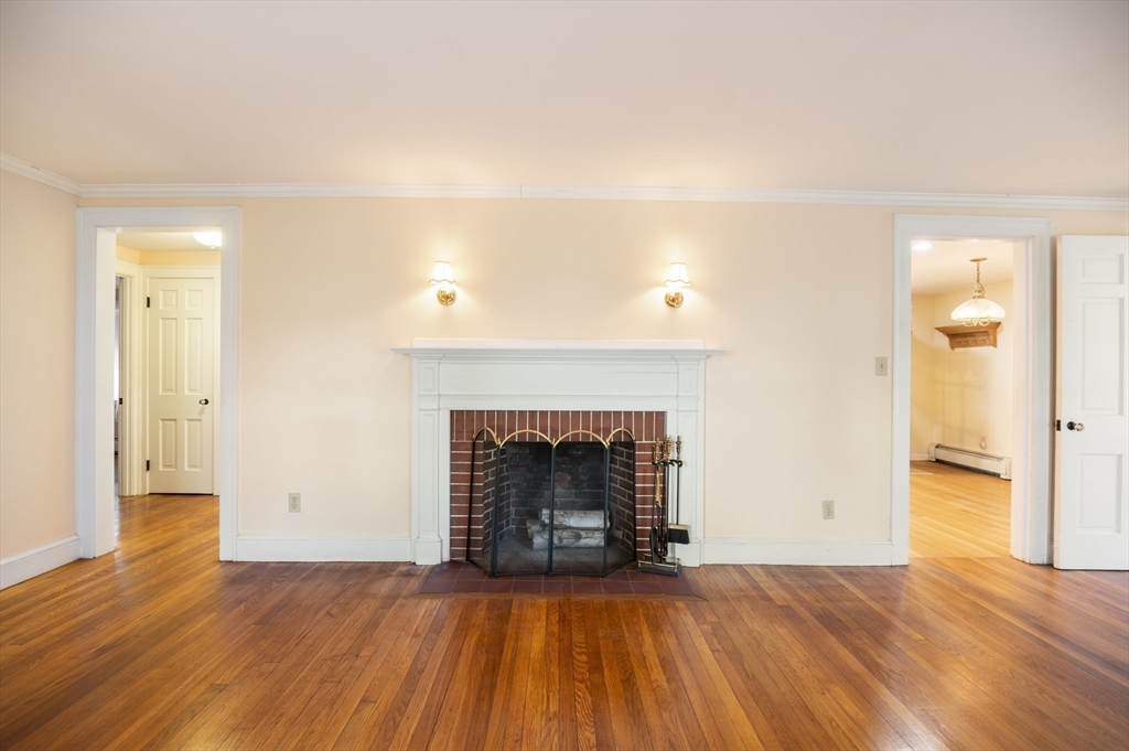 110 Linden Street Hamilton, MA 01982 - Photo 10 of 25 a view of empty room with wooden floor and fireplace