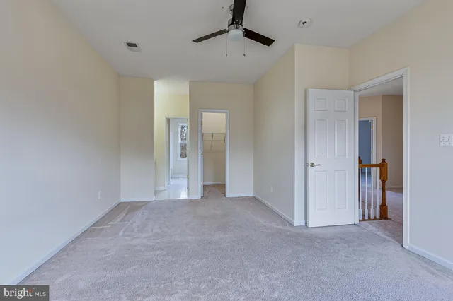 a bathroom with a bathtub shower sink vanity and toilet
