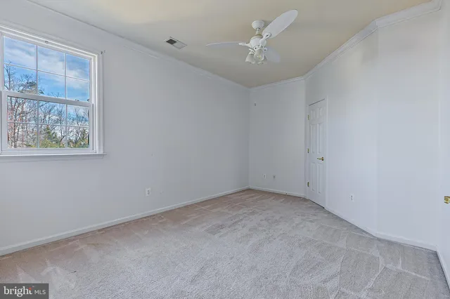 a view of an empty room and a window