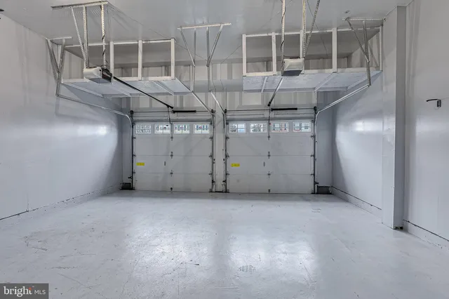 a view of a house with large windows and a small yard