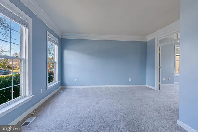 a view of a livingroom with a ceiling fan and window