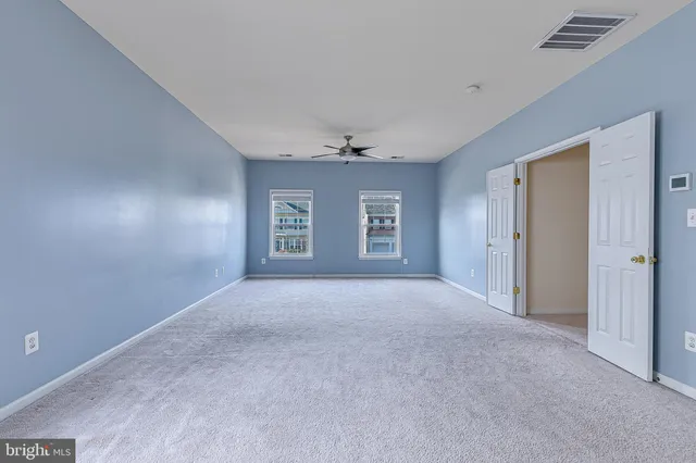 a view of a livingroom with wooden floor and entryway