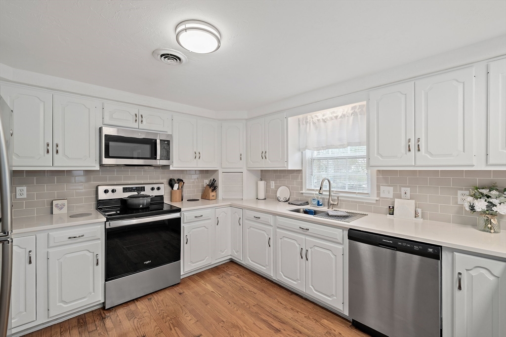 38 Roosevelt Street, Unit 2 Braintree, MA 02184 - Photo 1 of 17 a kitchen with white cabinets stainless steel appliances and sink