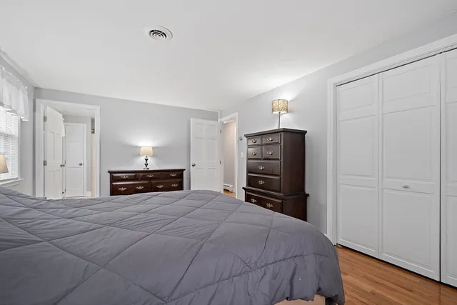 a view of a bedroom with furniture and closet