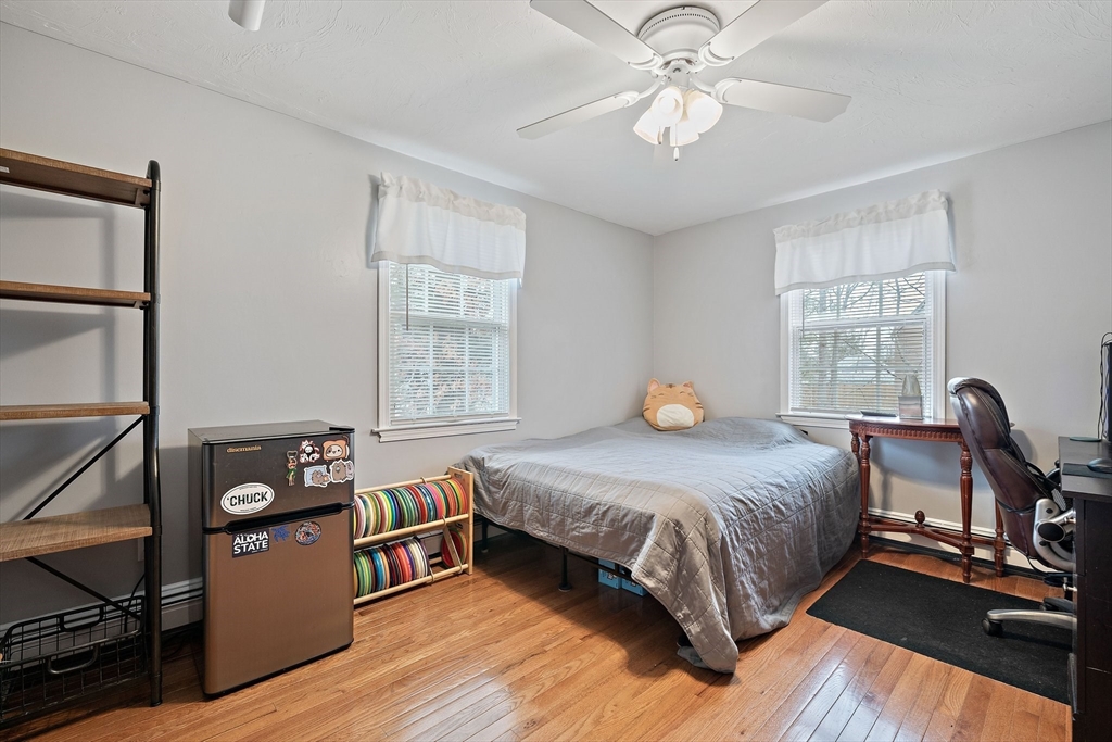 38 Roosevelt Street, Unit 2 Braintree, MA 02184 - Photo 17 of 17 a bedroom with a bed and wooden floor