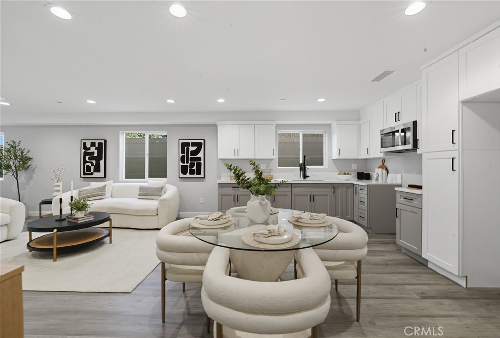 22022 Pioneer Boulevard Hawaiian Gardens, CA 90716 - Photo 11 of 50 a living room with furniture and a dining table with kitchen view