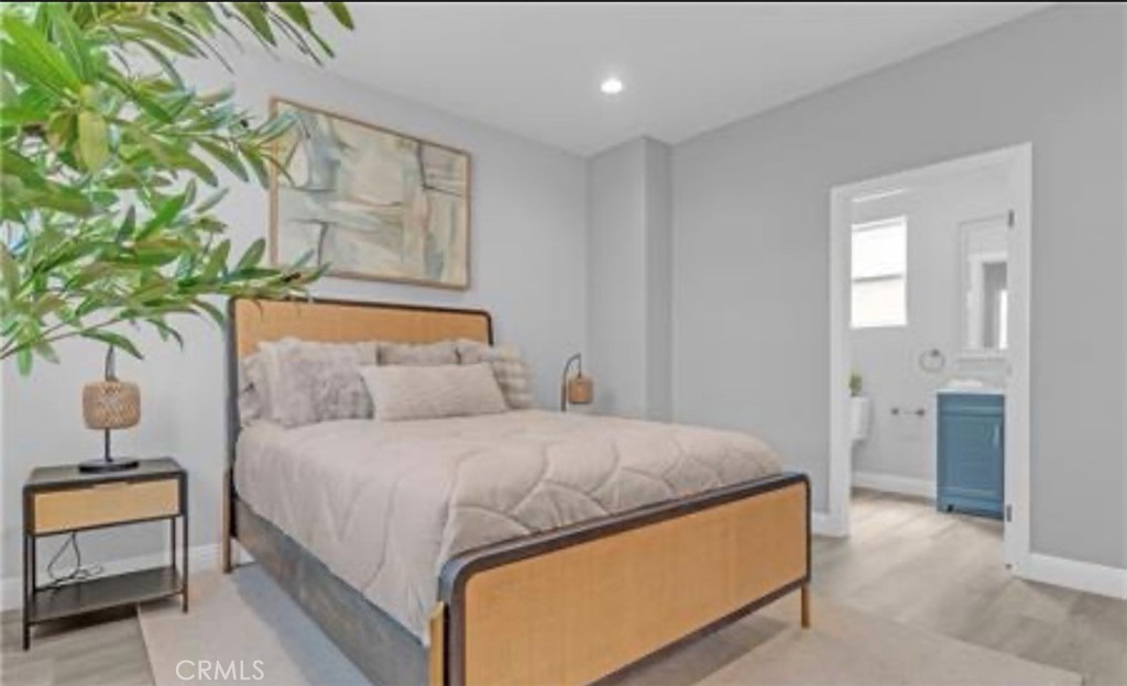 22022 Pioneer Boulevard Hawaiian Gardens, CA 90716 - Photo 16 of 50 a bedroom with a bed and a potted plant