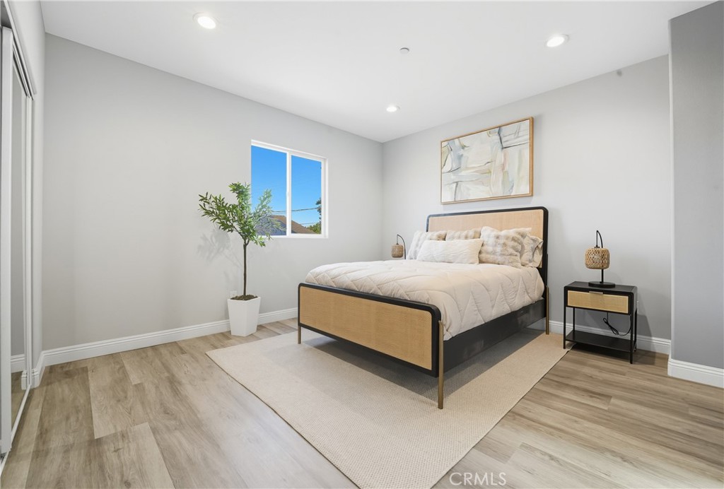 22022 Pioneer Boulevard Hawaiian Gardens, CA 90716 - Photo 17 of 50 a bedroom with a large bed and a potted plant