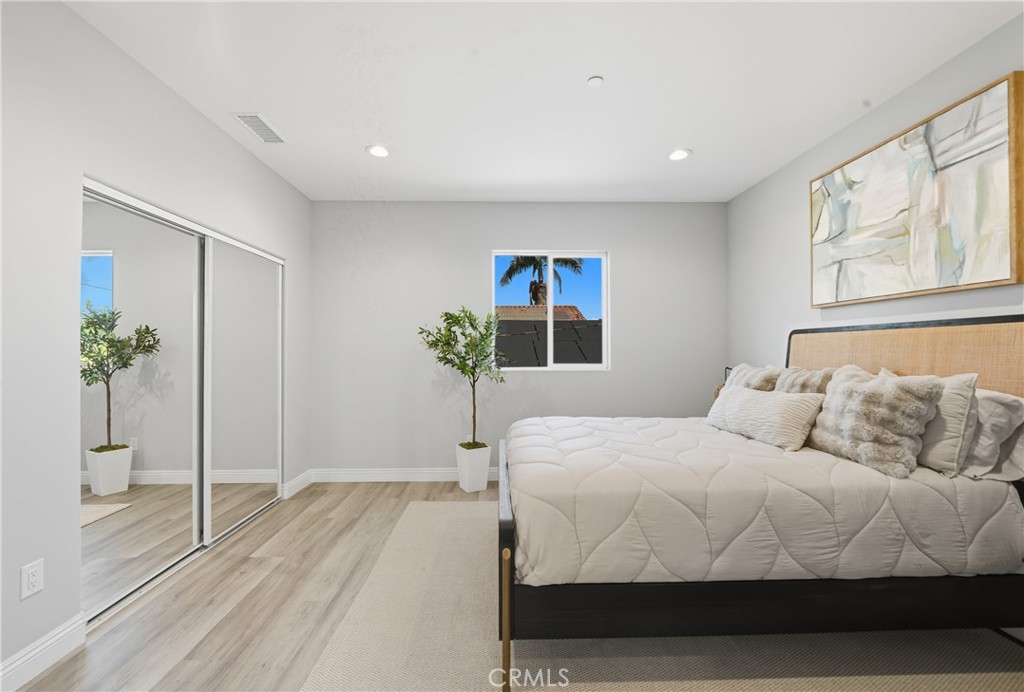 22022 Pioneer Boulevard Hawaiian Gardens, CA 90716 - Photo 18 of 50 a bedroom with a large bed and a potted plant