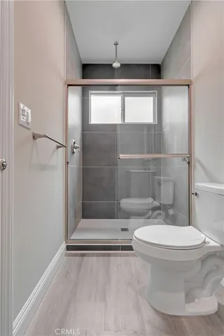 a bathroom with a toilet and a shower