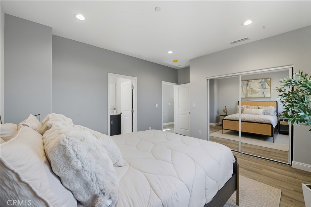 22022 Pioneer Boulevard Hawaiian Gardens, CA 90716 - Photo 19 of 50 a bedroom with a bed and a potted plant