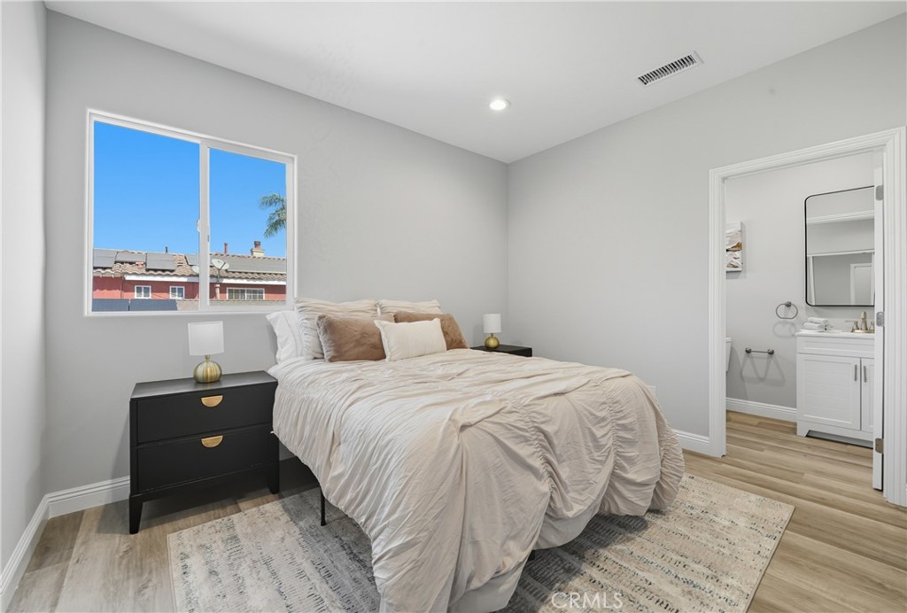 22022 Pioneer Boulevard Hawaiian Gardens, CA 90716 - Photo 21 of 50 a bedroom with a bed and a view of kitchen