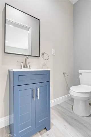 a bathroom with a toilet a sink and mirror