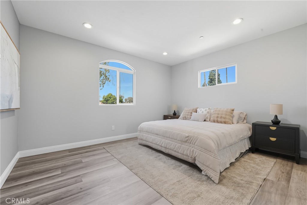22022 Pioneer Boulevard Hawaiian Gardens, CA 90716 - Photo 27 of 50 a bedroom with a large bed and a lamp