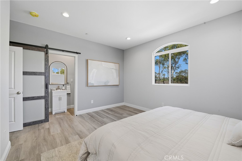 22022 Pioneer Boulevard Hawaiian Gardens, CA 90716 - Photo 28 of 50 a bedroom with a bed and a window