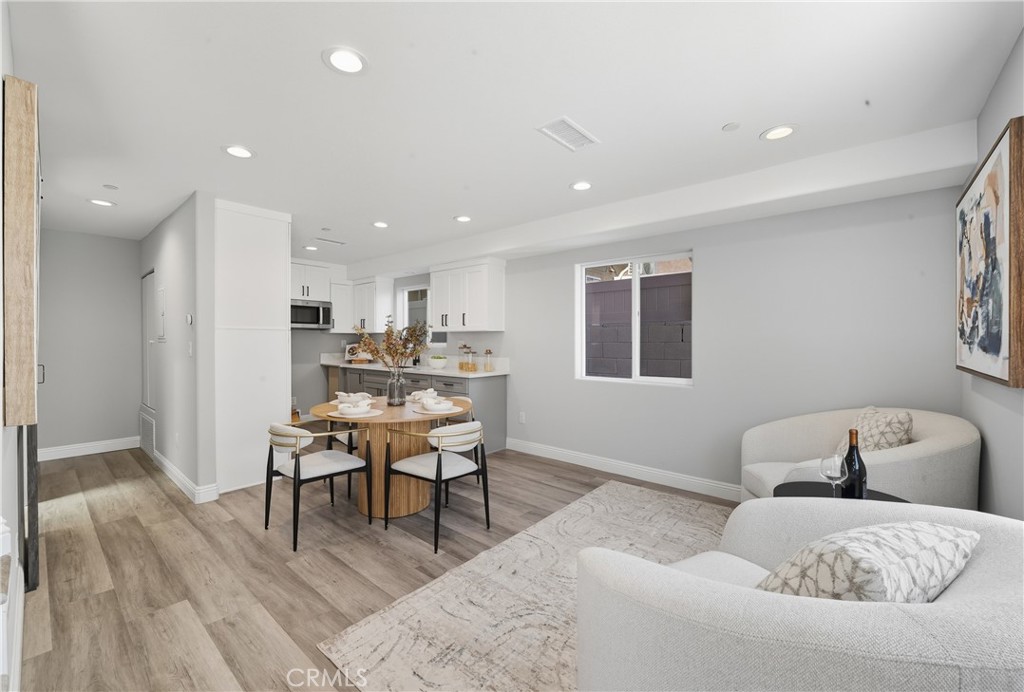 22022 Pioneer Boulevard Hawaiian Gardens, CA 90716 - Photo 40 of 50 a living room with furniture and a dining table with kitchen view