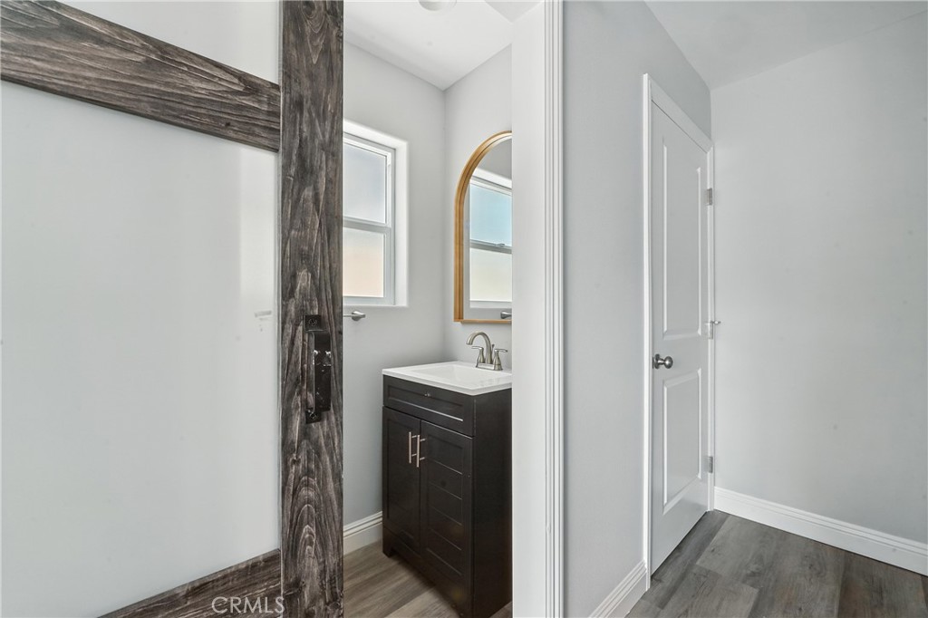 22022 Pioneer Boulevard Hawaiian Gardens, CA 90716 - Photo 43 of 50 a en suite bathroom with a granite countertop sink and a mirror