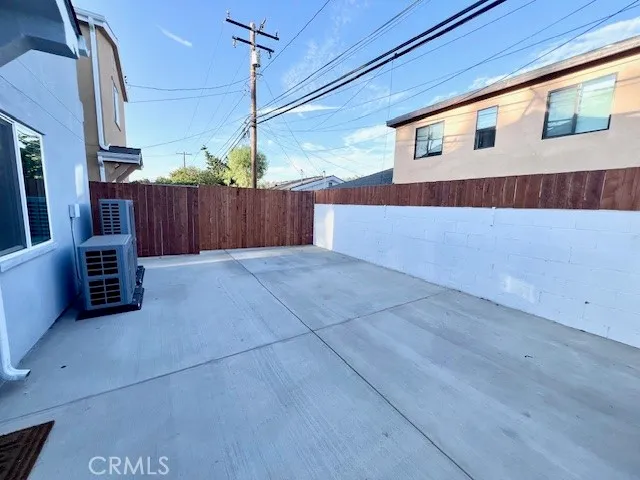 a view of a house with backyard and wooden fence