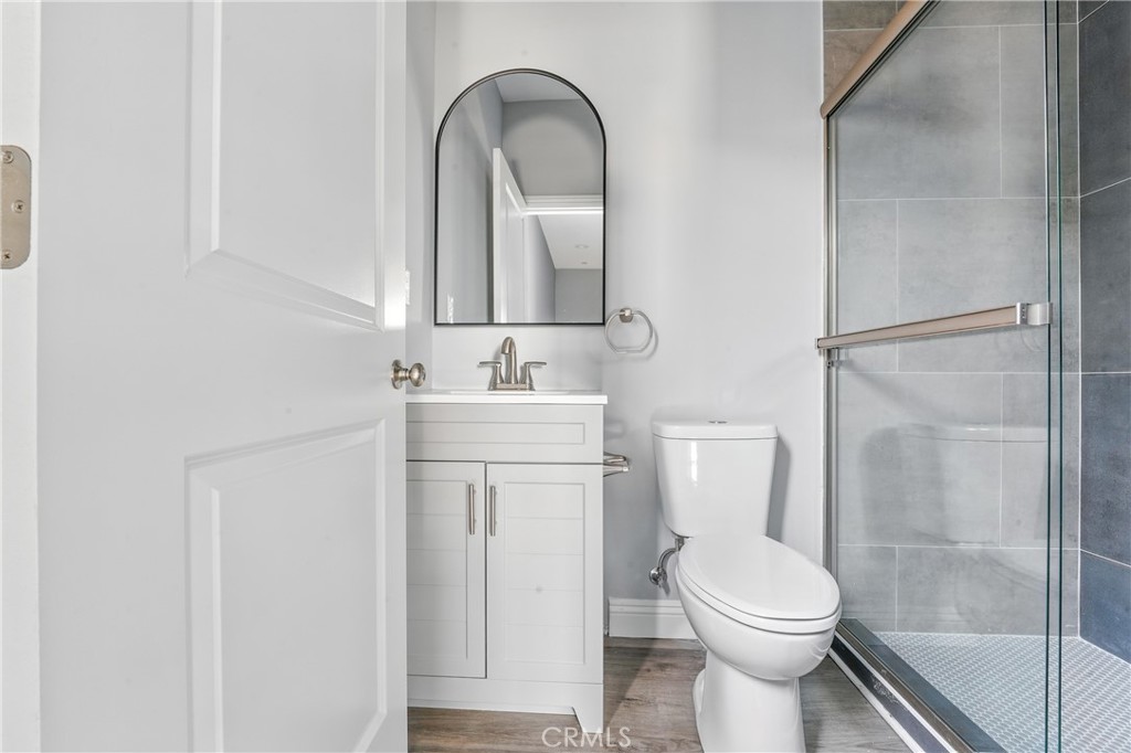 22022 Pioneer Boulevard Hawaiian Gardens, CA 90716 - Photo 47 of 50 a bathroom with a toilet a sink and a mirror