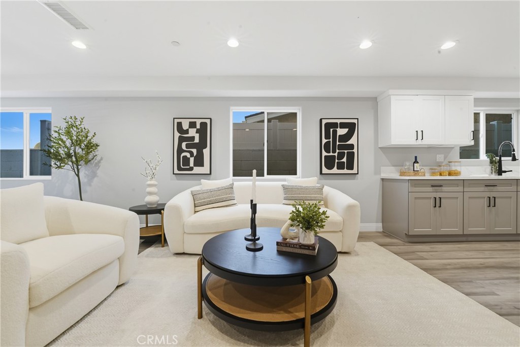 22022 Pioneer Boulevard Hawaiian Gardens, CA 90716 - Photo 9 of 50 a living room with furniture and a potted plant