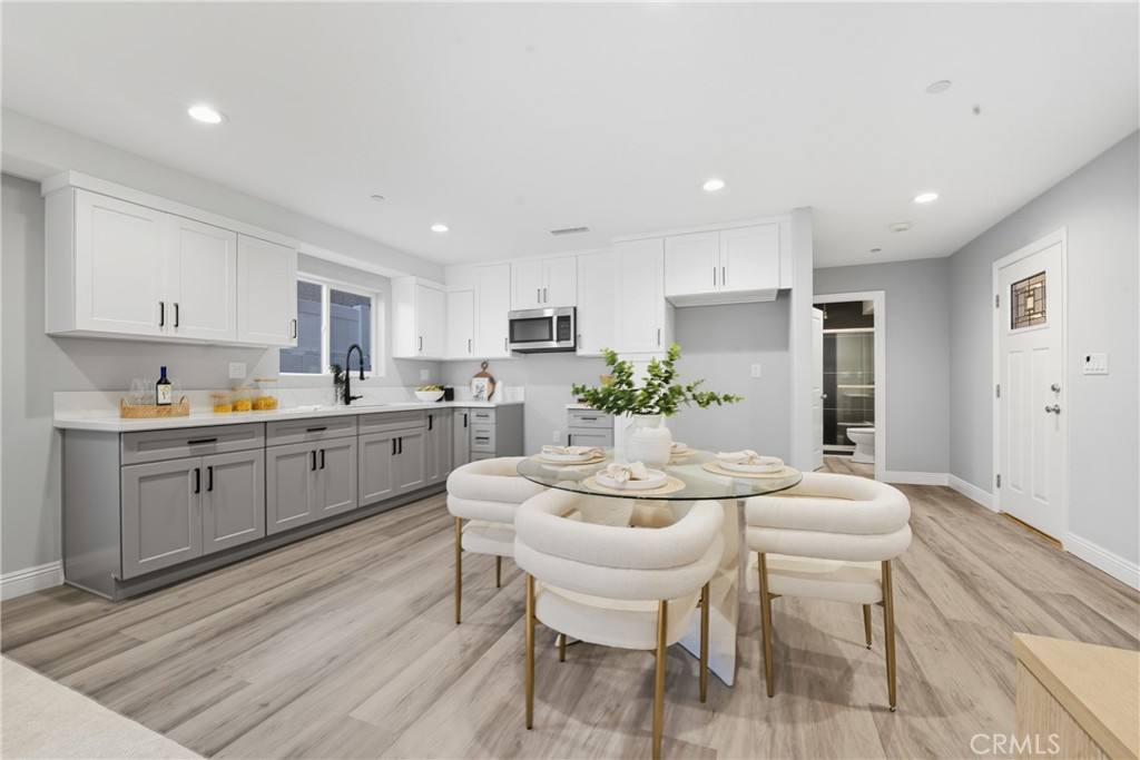 22022 Pioneer Boulevard Hawaiian Gardens, CA 90716 - Photo 10 of 50 a kitchen with a dining table chairs and white cabinets