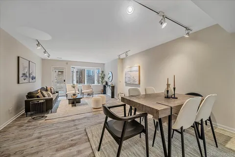 a view of a dining room with furniture and wooden floor