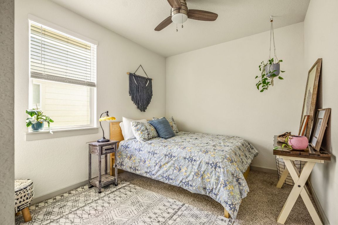 10002 Baden Lane Austin, TX 78754 - Photo 21 of 28 Bedroom with light colored carpet and a ceiling fan