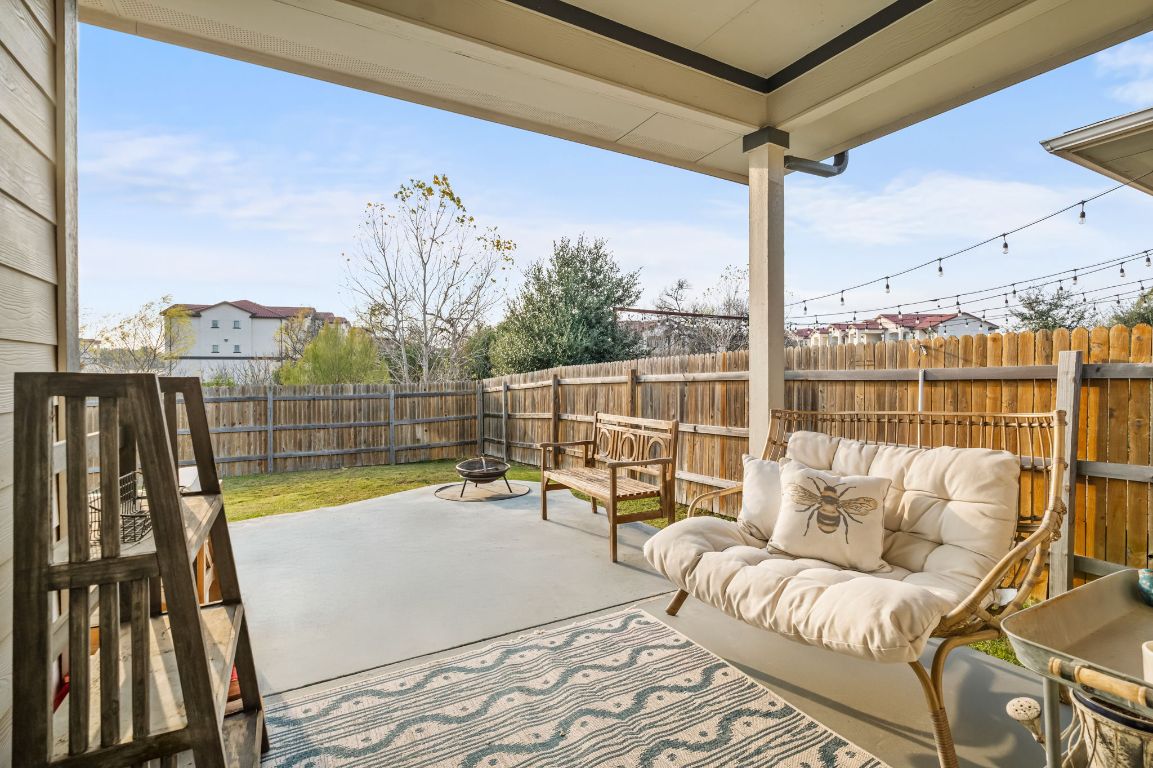 10002 Baden Lane Austin, TX 78754 - Photo 23 of 28 Fenced backyard featuring a patio and an outdoor living space with a fire pit