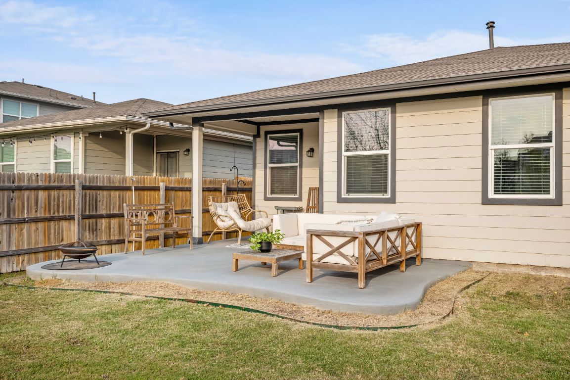 10002 Baden Lane Austin, TX 78754 - Photo 27 of 28 Rear view of house with an outdoor living space with a fire pit, a patio, and roof with shingles