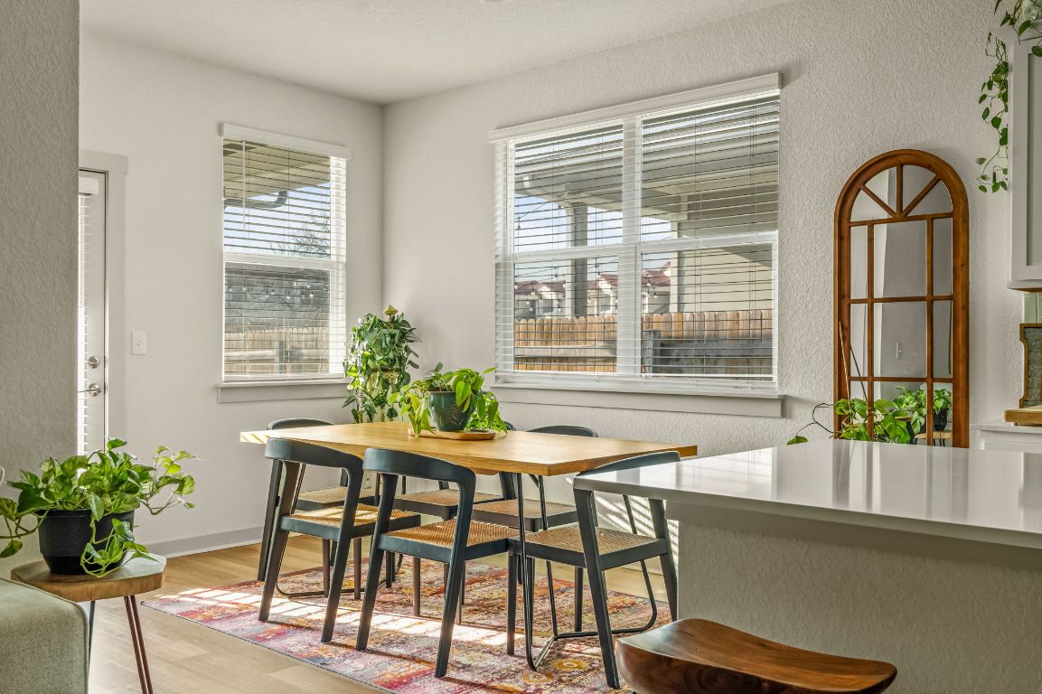 10002 Baden Lane Austin, TX 78754 - Photo 8 of 28 Dining space featuring a textured wall and light wood finished floors