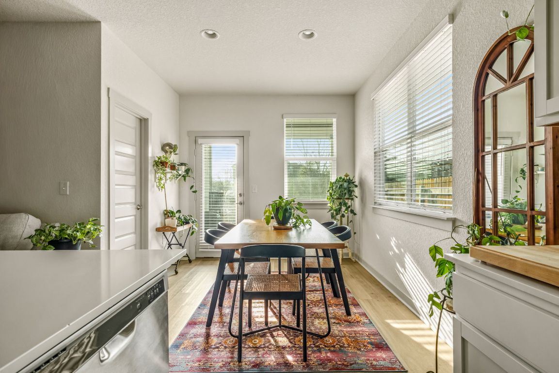 10002 Baden Lane Austin, TX 78754 - Photo 9 of 28 Dining area featuring light wood-type flooring, a textured ceiling, and recessed lighting