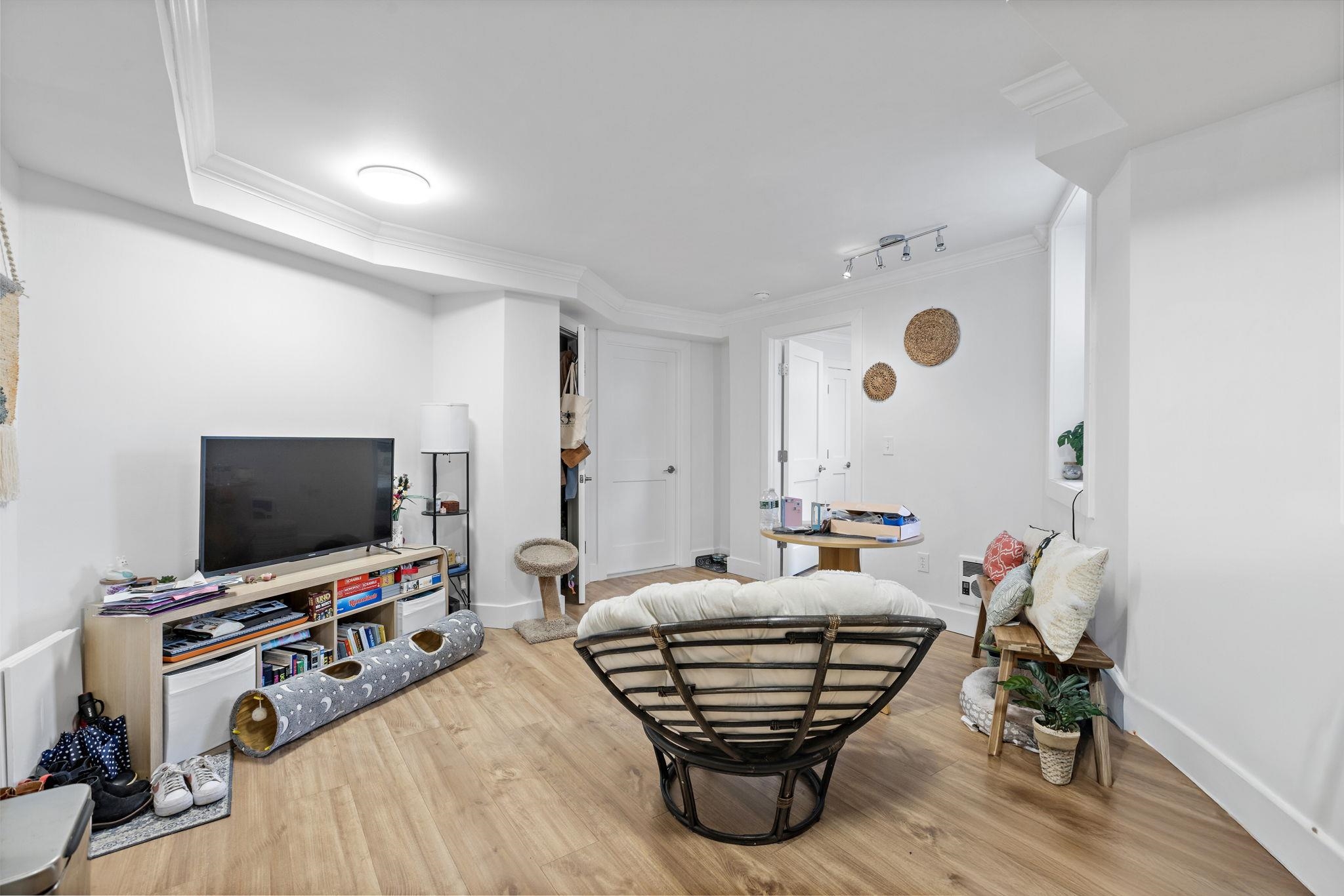 151 Sip Avenue, Unit 38 Jersey City, NJ 07306 - Photo 1 of 12 a living room with furniture and a flat screen tv