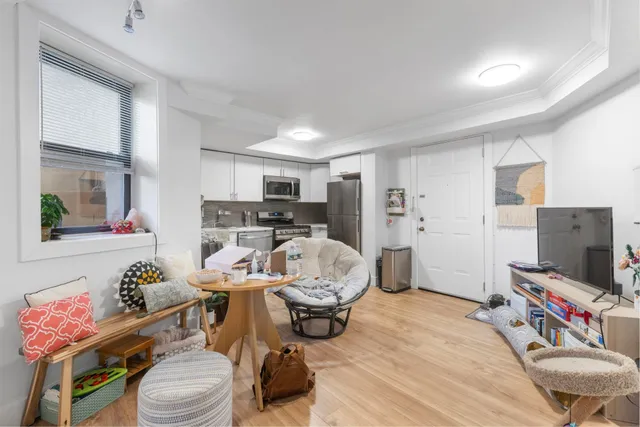 a room with furniture a flat screen tv and a window