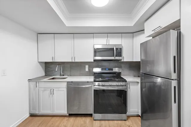a kitchen with a sink stove and refrigerator