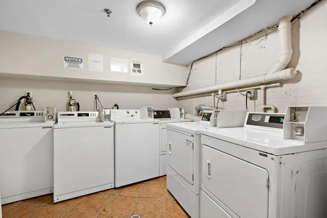 a kitchen with cabinets appliances a sink and a counter space