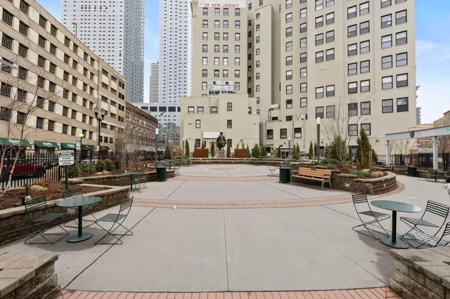 a view of a building and bench on the street
