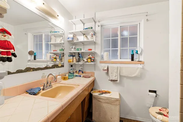 a room with a sink and a bed