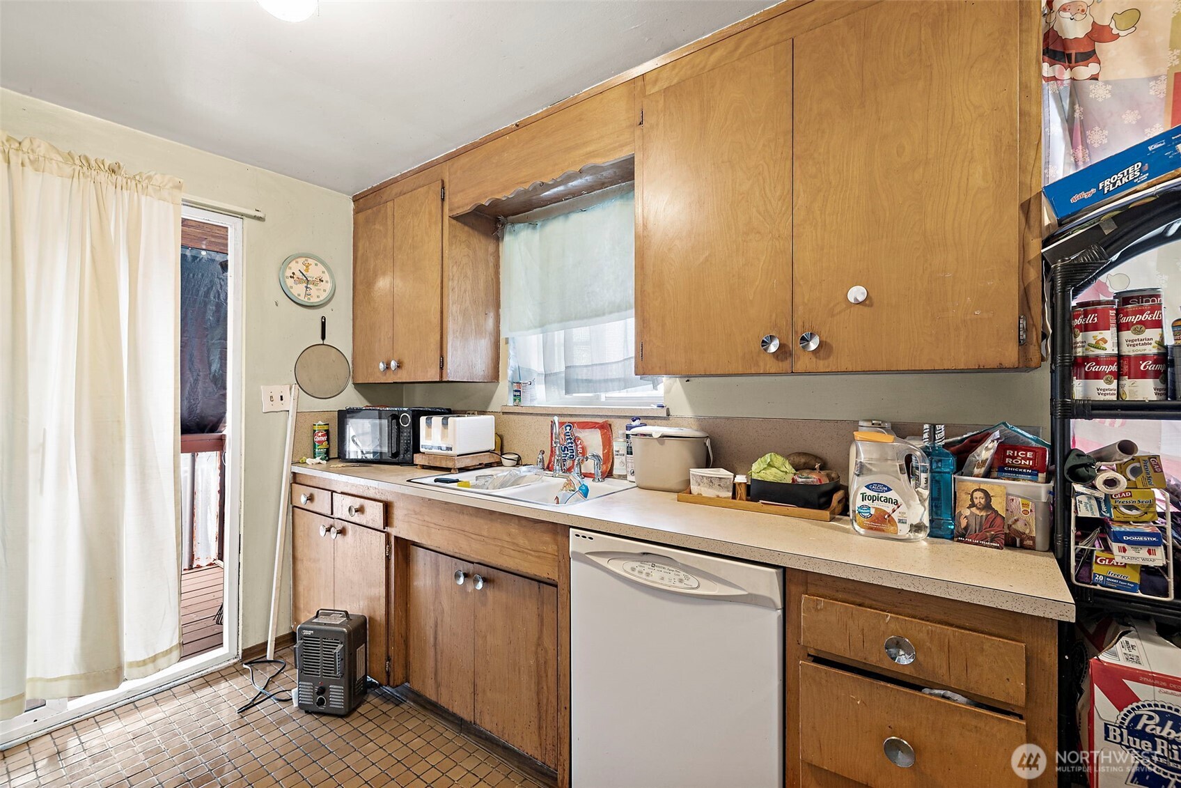 8829 20th Avenue Southwest Seattle, WA 98106 - Photo 16 of 40 a kitchen with a sink cabinets and window