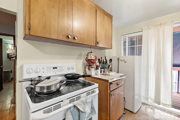 a kitchen with a stove and a white cabinets