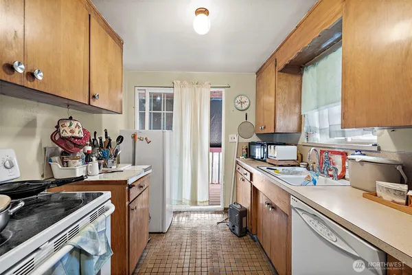 a kitchen with a sink stove and cabinets