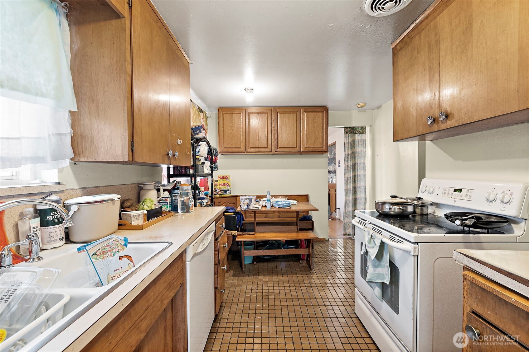 8829 20th Avenue Southwest Seattle, WA 98106 - Photo 20 of 40 a kitchen with stainless steel appliances granite countertop a stove a sink and a microwave