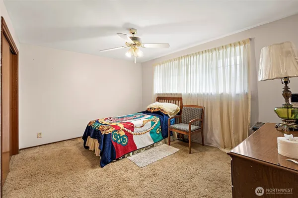 a bedroom with a bed and a chandelier
