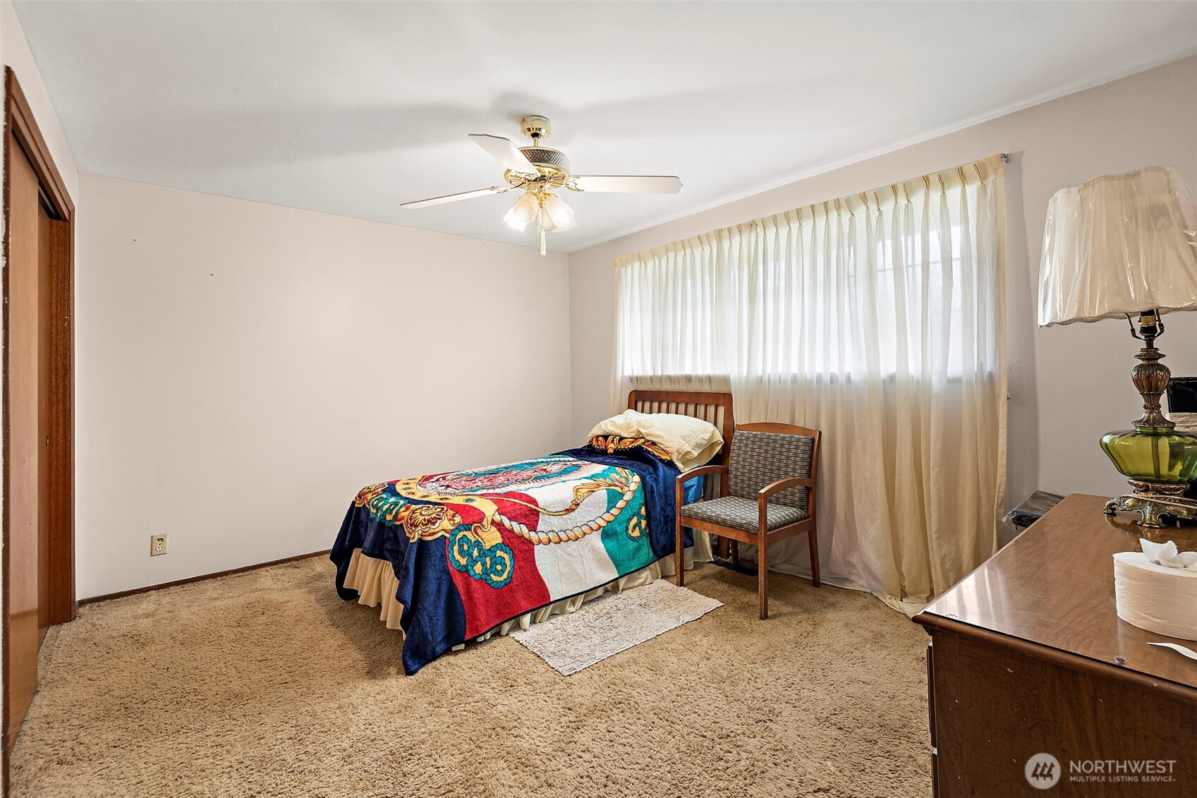 8829 20th Avenue Southwest Seattle, WA 98106 - Photo 8 of 40 a bedroom with a bed and a chandelier