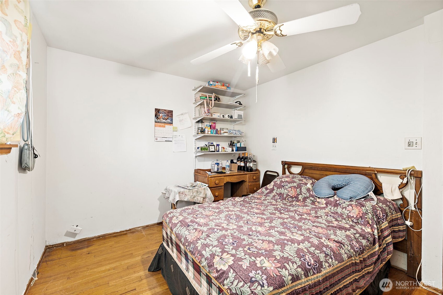 8829 20th Avenue Southwest Seattle, WA 98106 - Photo 9 of 40 a bedroom with a bed and a chandelier