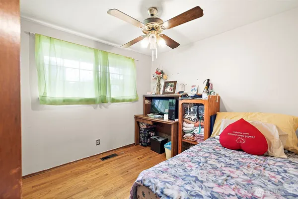 a bedroom with bed and a chandelier