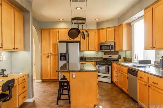 a kitchen with a sink appliances and cabinets
