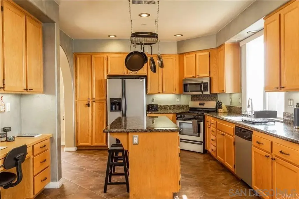a kitchen with a sink appliances and cabinets