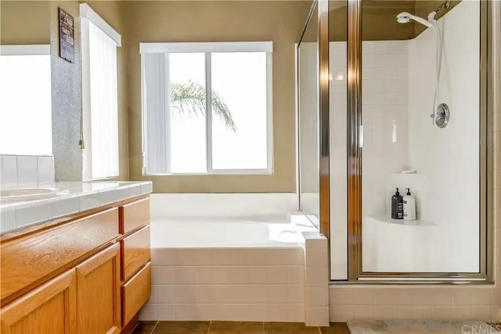531 Poets Square Fallbrook, CA 92028 - Photo 12 of 19 a bathroom with a bathtub and a shower