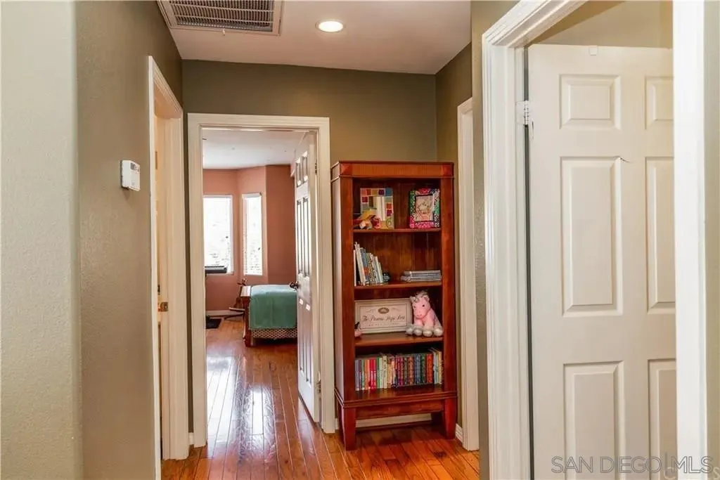 531 Poets Square Fallbrook, CA 92028 - Photo 16 of 19 a view of a bedroom with wooden floor and closet