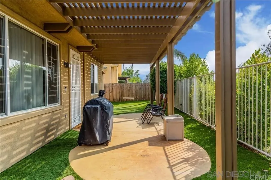 531 Poets Square Fallbrook, CA 92028 - Photo 19 of 19 a view of a porch with a floor to ceiling window and wooden fence
